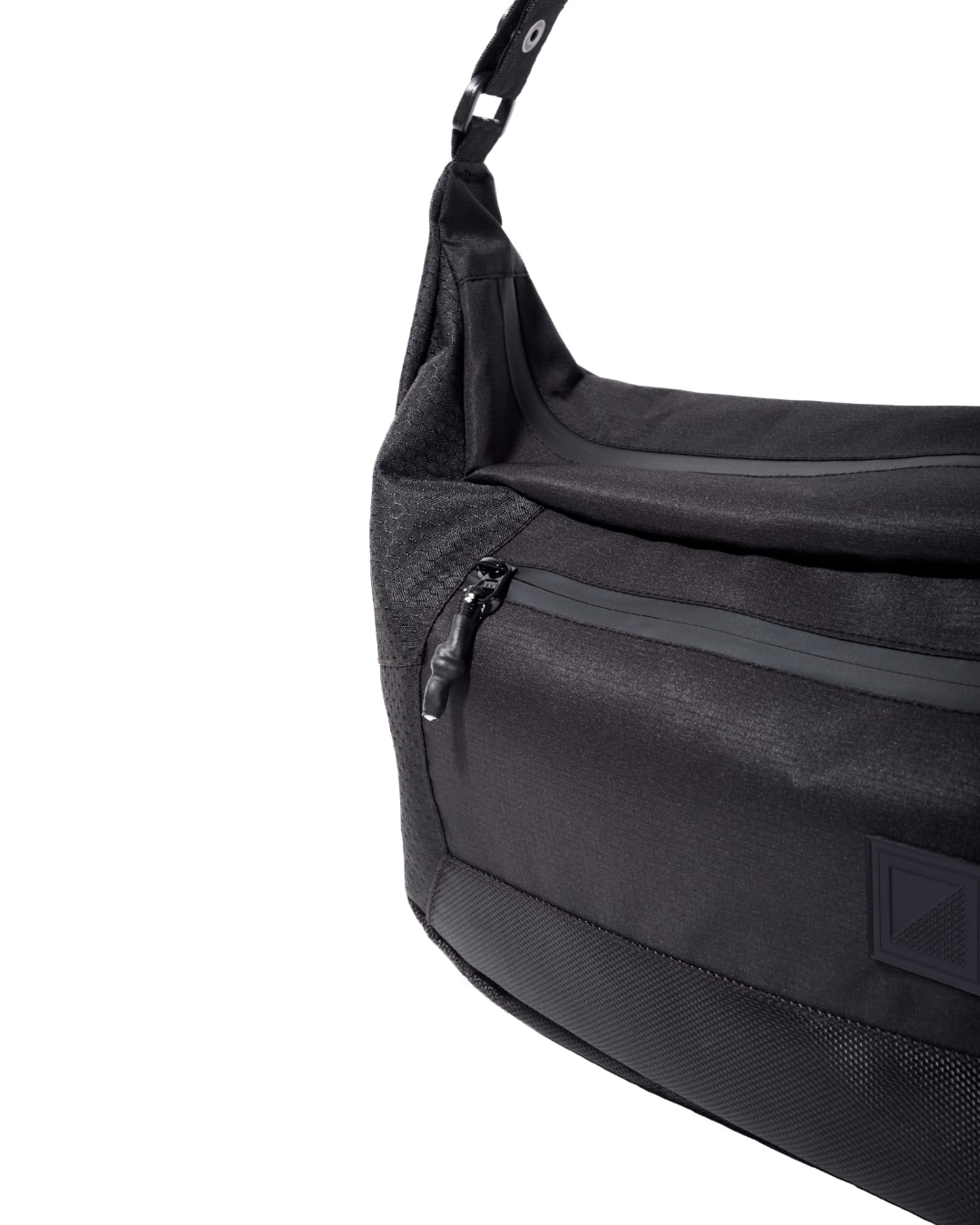 Close-up front angled view of the black SYMA Drone highlighting its water-repellent front zipper, rubberized paracord pull, and stealth logo patch. Urban sling bag.