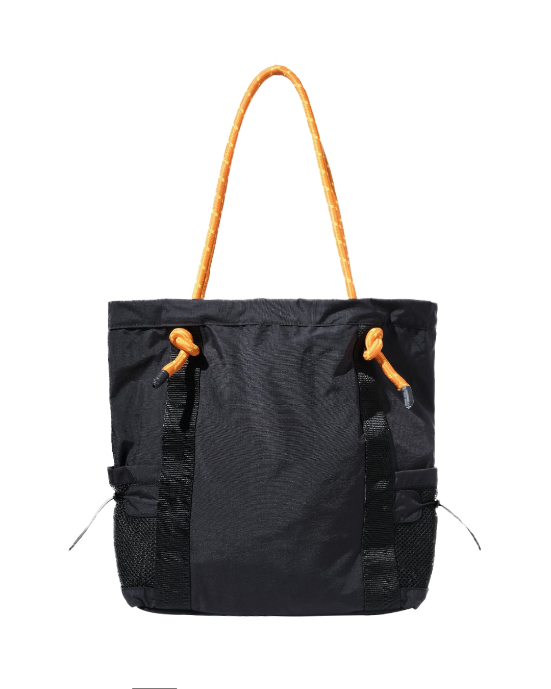 Rear vertical view of the black SYMA Noble minimalist everyday tote bag, showing the clean nylon crinkle exterior, vertical webbing reinforcement, and contrasting orange paracord straps