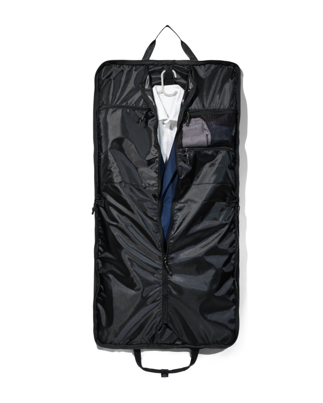 Straight interior view of the fully unzipped black SYMA Motion revealing a white shirt and navy suit jacket on a hanger, alongside an internal mesh pocket. Travel garment bag.