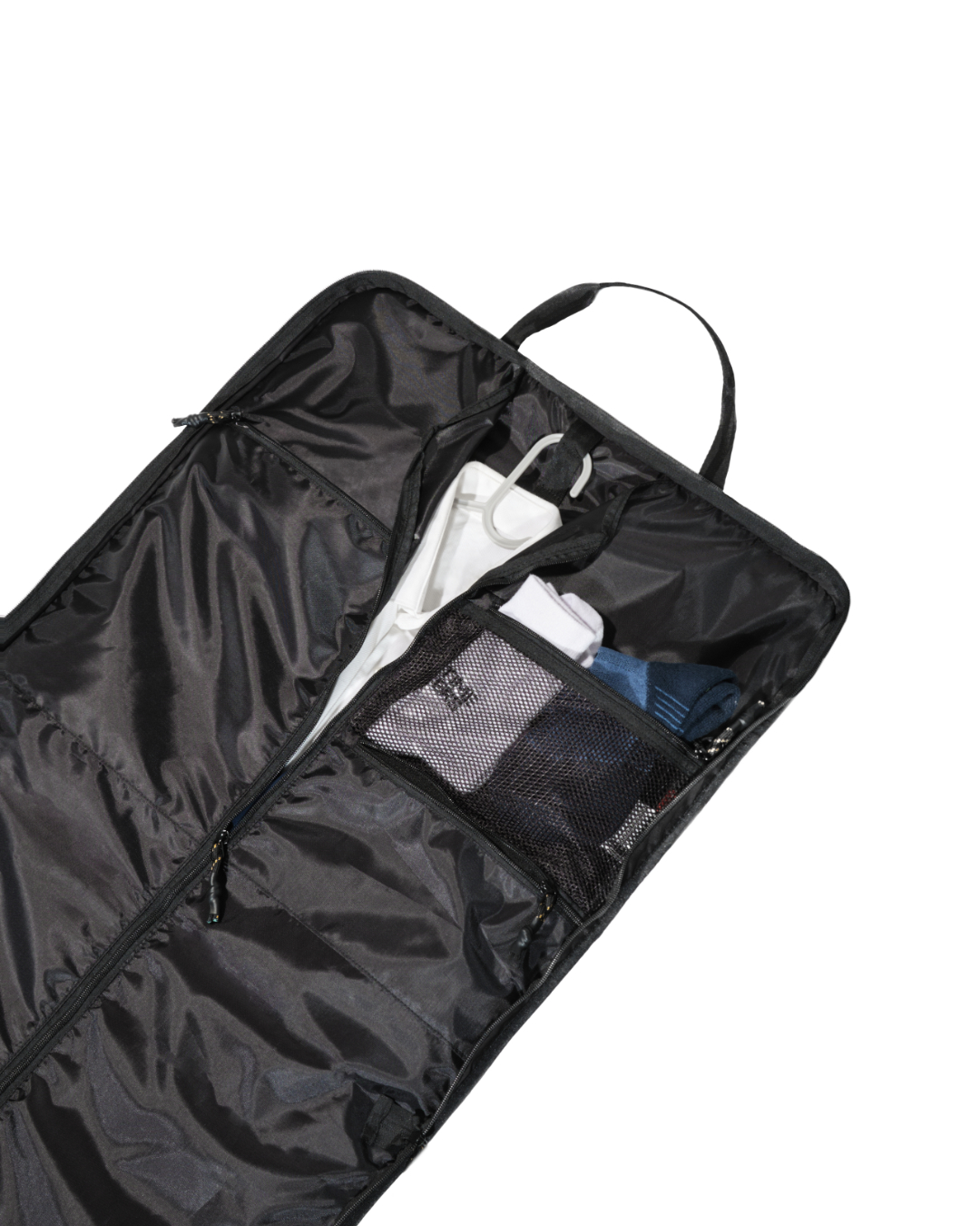 Angled interior view of the open black SYMA Motion revealing a hanger loop holding a white shirt and a zippered mesh pocket storing folded accessories. Travel garment bag.