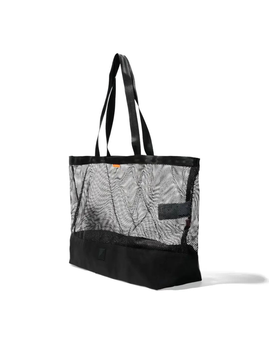 Angled front view of the black SYMA Peach highlighting its deep spatial volume, transparent mesh upper, and solid ripstop base. Large urban tote bag.