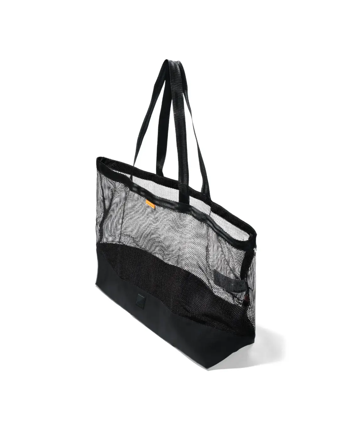 High-angle side view of the black SYMA Peach highlighting its wide top opening, sturdy webbing handles, transparent mesh body, and solid ripstop base. Large urban tote bag.