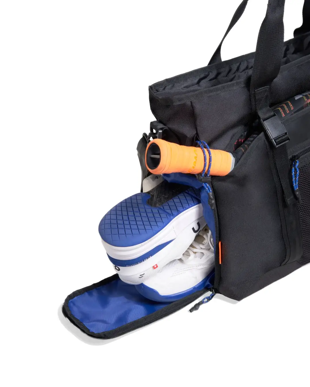 Close-up view of athletic shoes inside dedicated compartment of SYMA Miles Racket-Tote Black. Padel & tennis bag