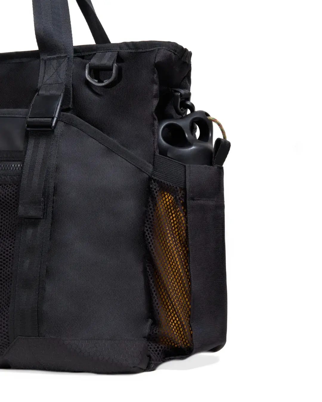 Detail of side mesh water bottle pocket on SYMA Miles Racket-Tote Black. Padel & tennis bag