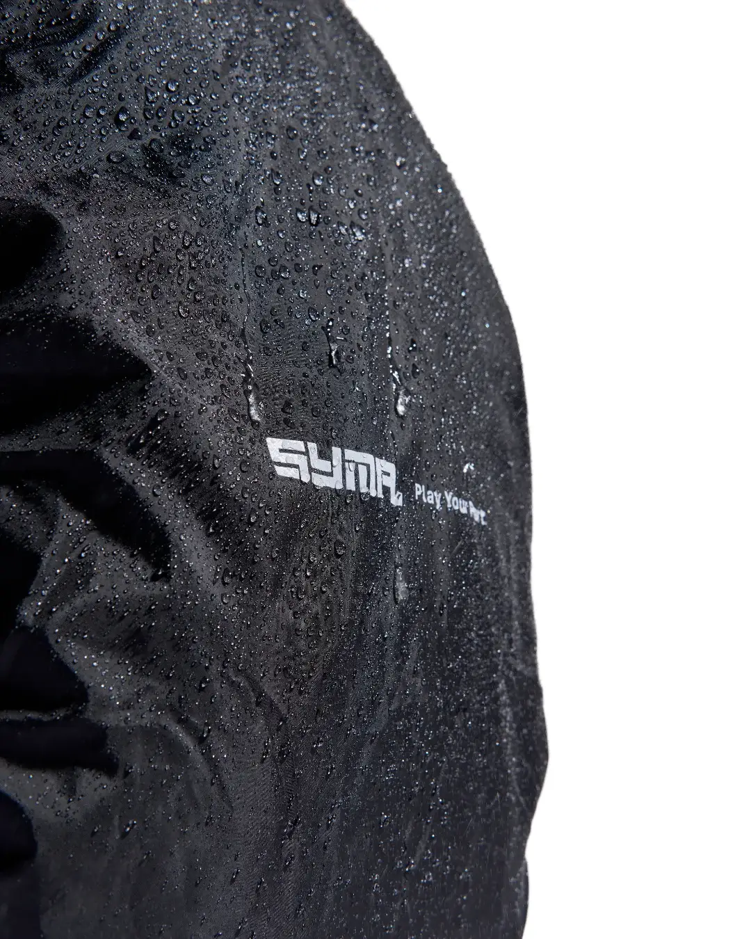 Close-up view of black SYMA Daytripper covered in water droplets, highlighting its waterproof fabric and white logo. Packable backpack rain cover.
