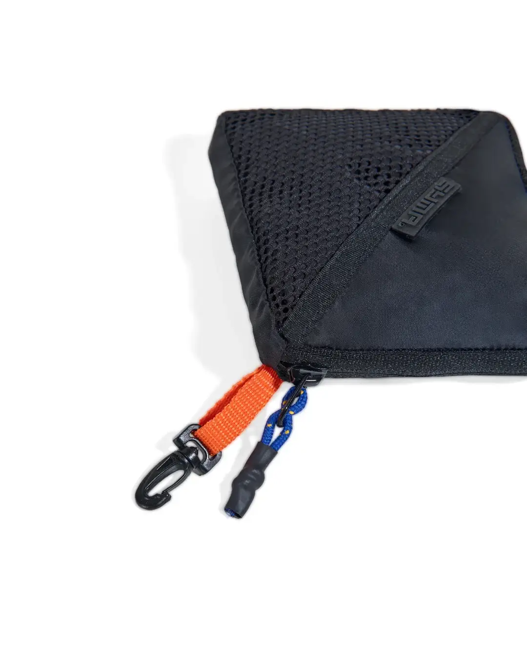Extreme close-up view of black SYMA Daytripper compact pouch highlighting breathable mesh panel, orange loop, and zipper pull. Packable backpack rain cover.