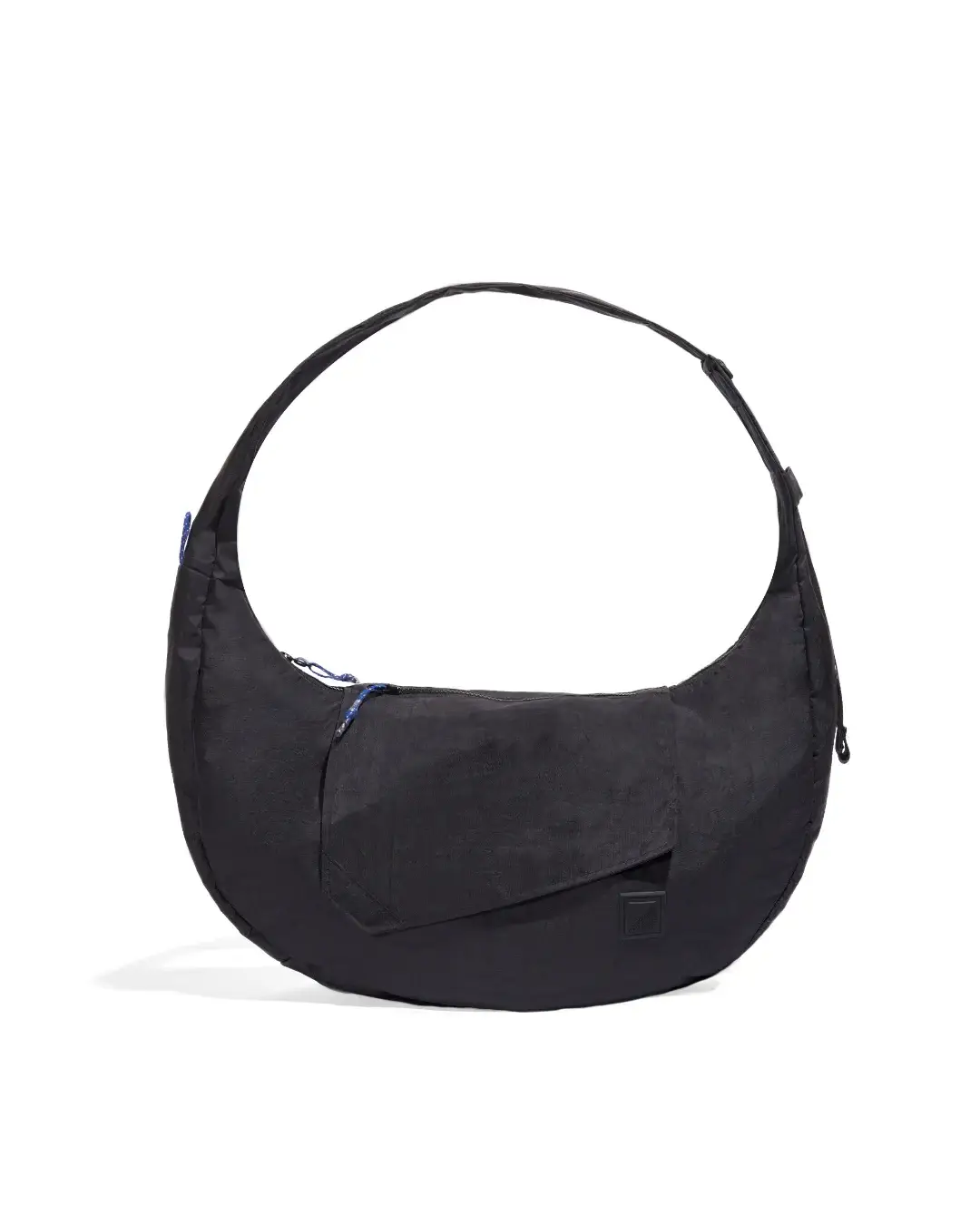 Front view of SYMA Fable Sling Bag Black showing quick access flap pocket. 16L oversized crossbody bag