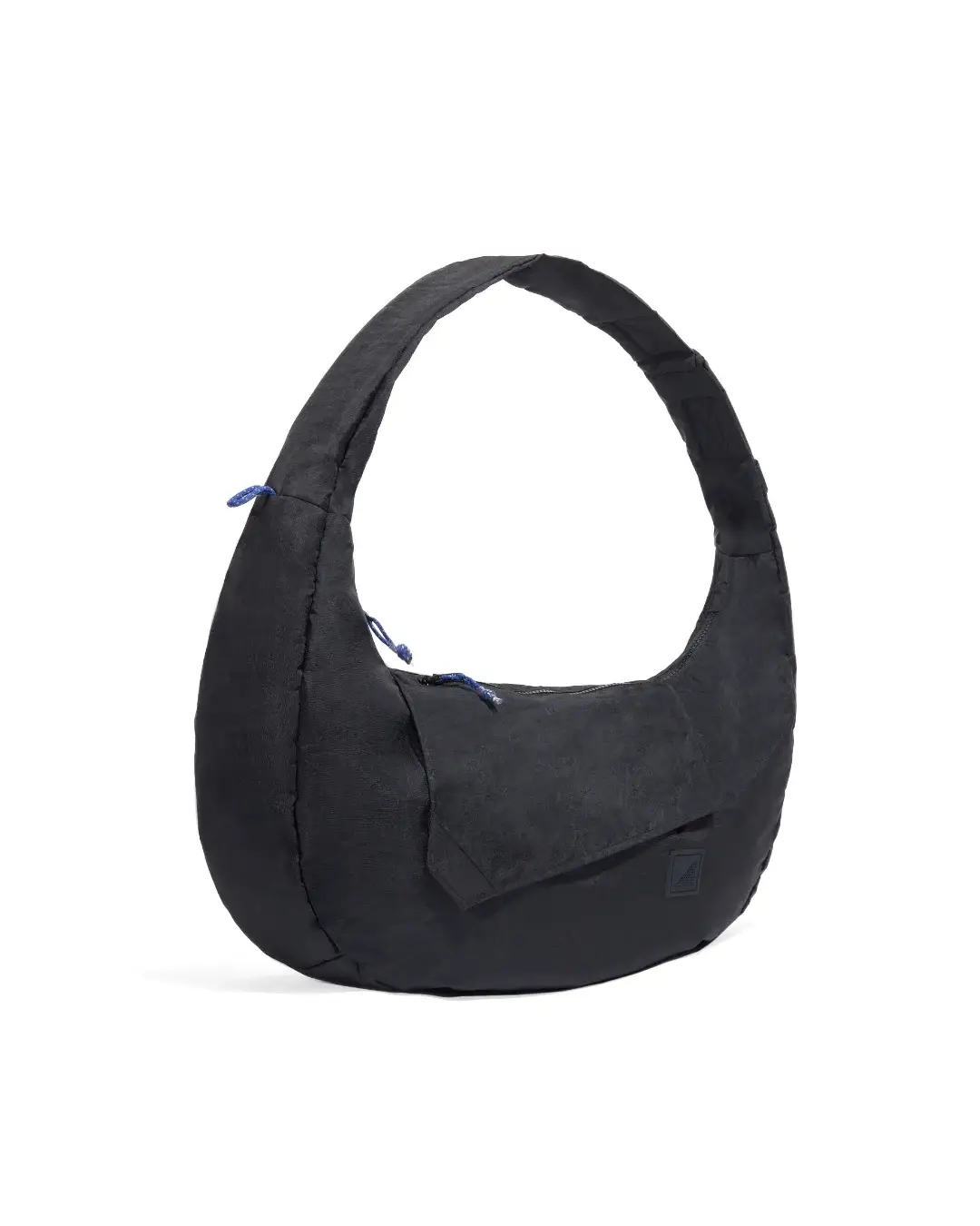 Angled view of SYMA Fable Sling Bag Black showing 400D crinkle polyester and bold silhouette. Urban utility bag
