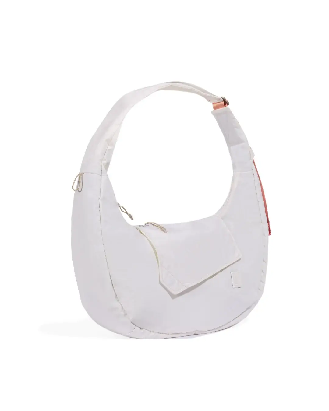 Left angled view of SYMA Fable Sling Bag Light Cream showing side charm loop. Minimalist everyday sling bag