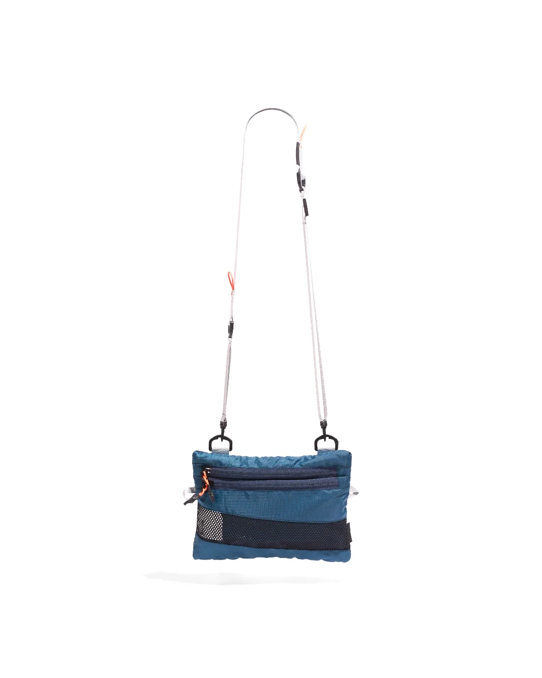 Front suspended view of the SYMA Mantra navy sacoche bag, highlighting its durable polyester ripstop exterior, dual front zipper pockets with orange pullers, bottom mesh detailing, and adjustable removable strap