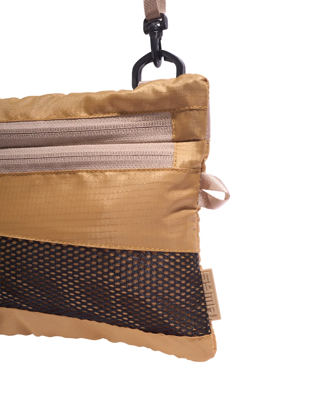 Extreme close-up detail of the SYMA Mantra khaki sacoche bag, showing the 210D polyester ripstop grid, front zipper tracks, black bottom mesh panel, side webbing loop, and a subtle khaki SYMA logo tag