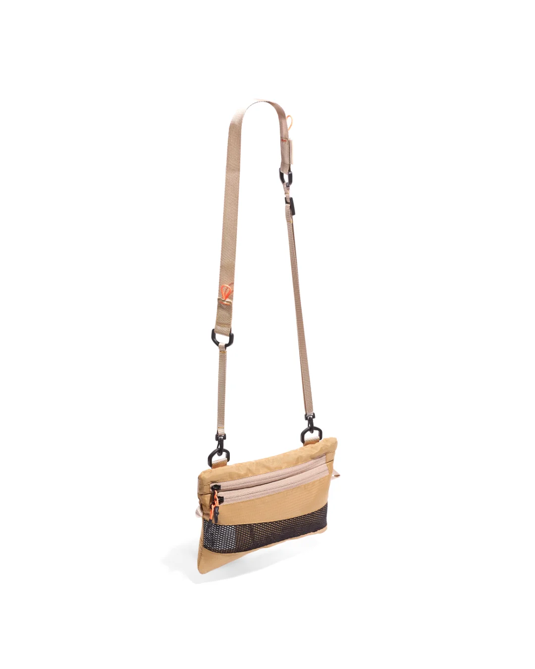 Low-angle three-quarter suspended view of the SYMA Mantra khaki sacoche bag, highlighting its durable ripstop body, bottom black mesh panel, front zipper compartments with orange pullers, and khaki adjustable strap with black hardware