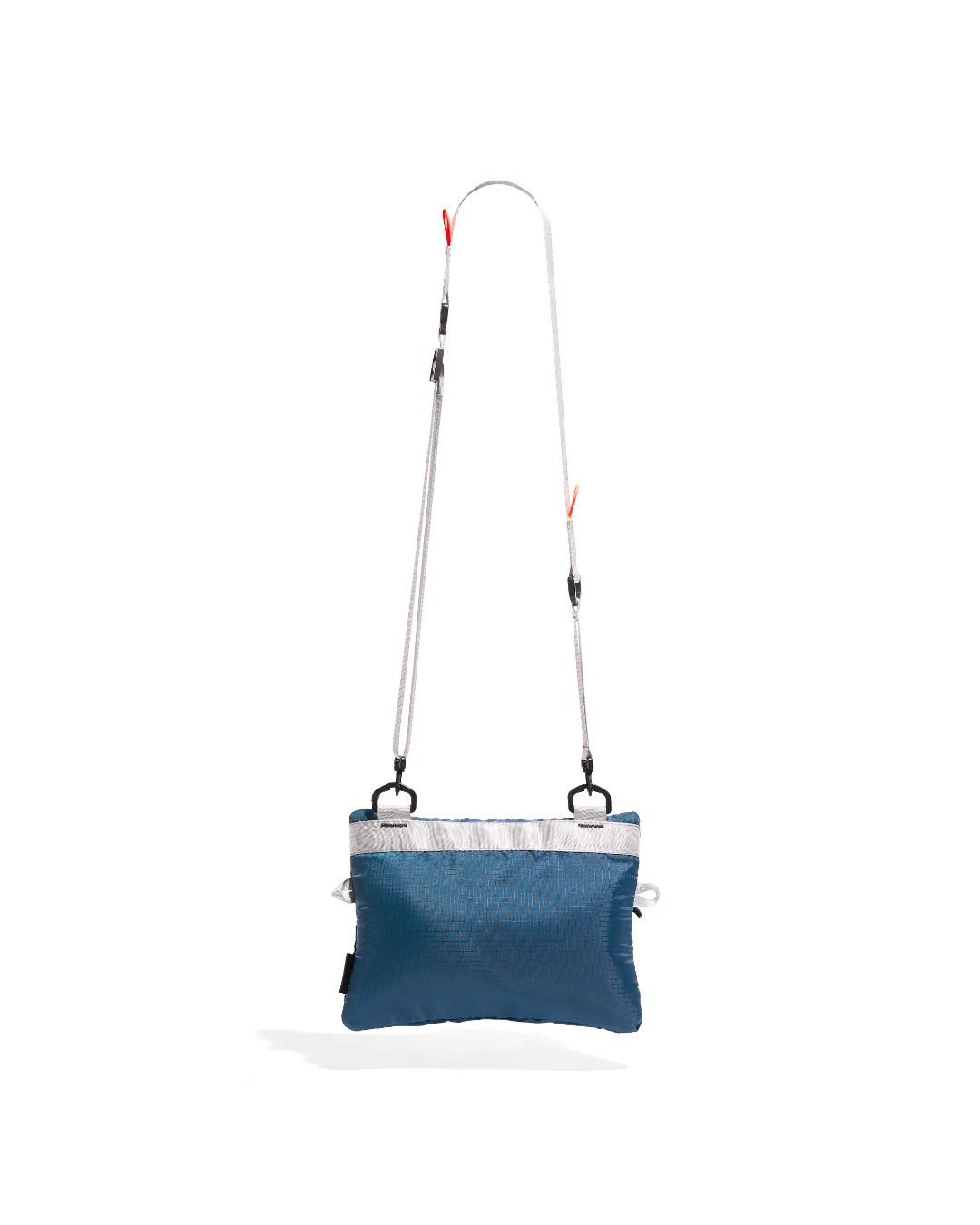 Rear suspended view of the SYMA Mantra navy sacoche bag, showcasing the clean ripstop polyester back panel, a reinforced horizontal gray webbing strip acting as an attachment point, and a full view of the adjustable light gray crossbody strap