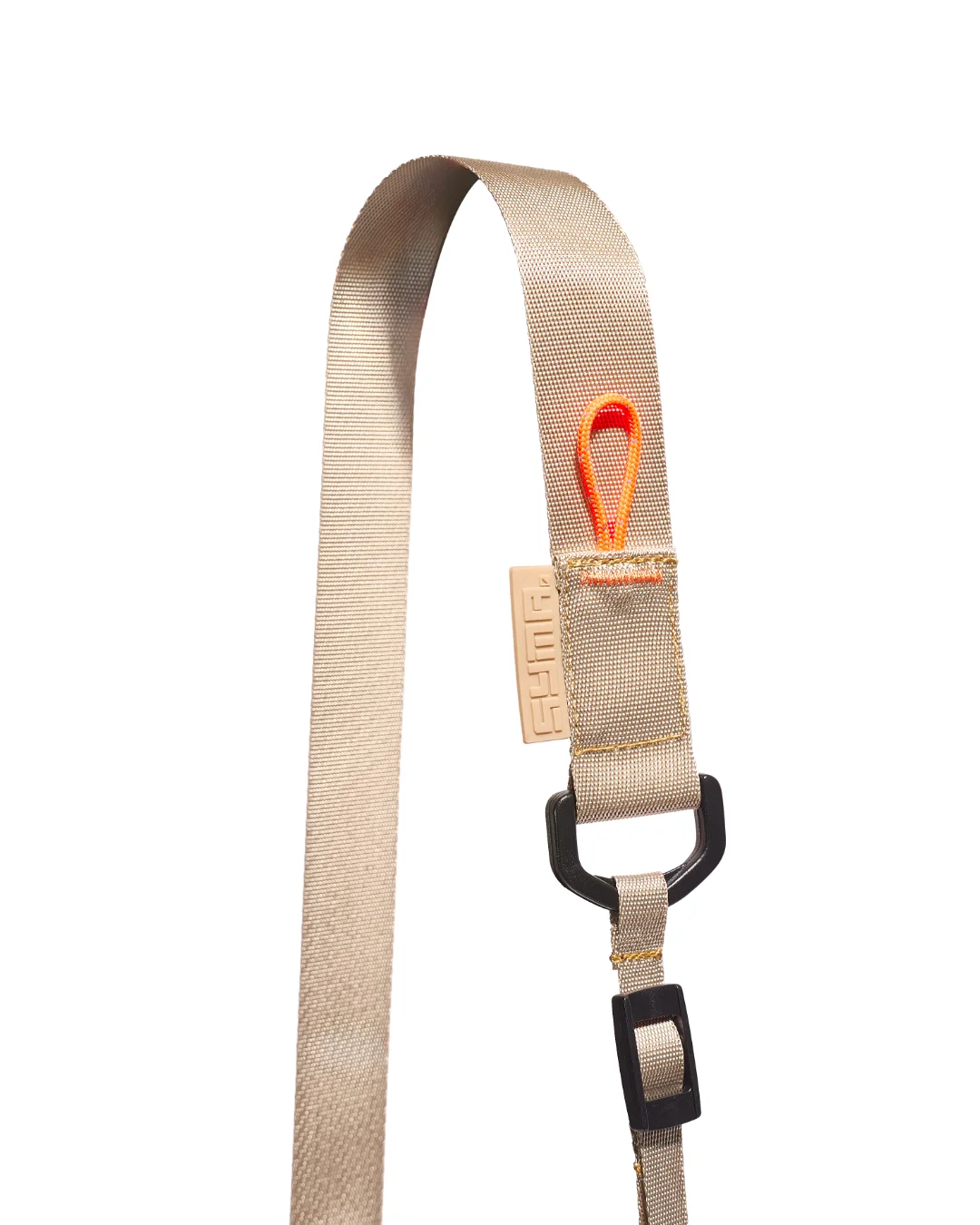 Extreme close-up detail of the SYMA Mantra khaki sacoche bag strap, highlighting the khaki nylon webbing, a tonal khaki embossed SYMA logo tag, a black D-ring with an adjuster buckle, and an orange paracord loop secured with orange box stitching